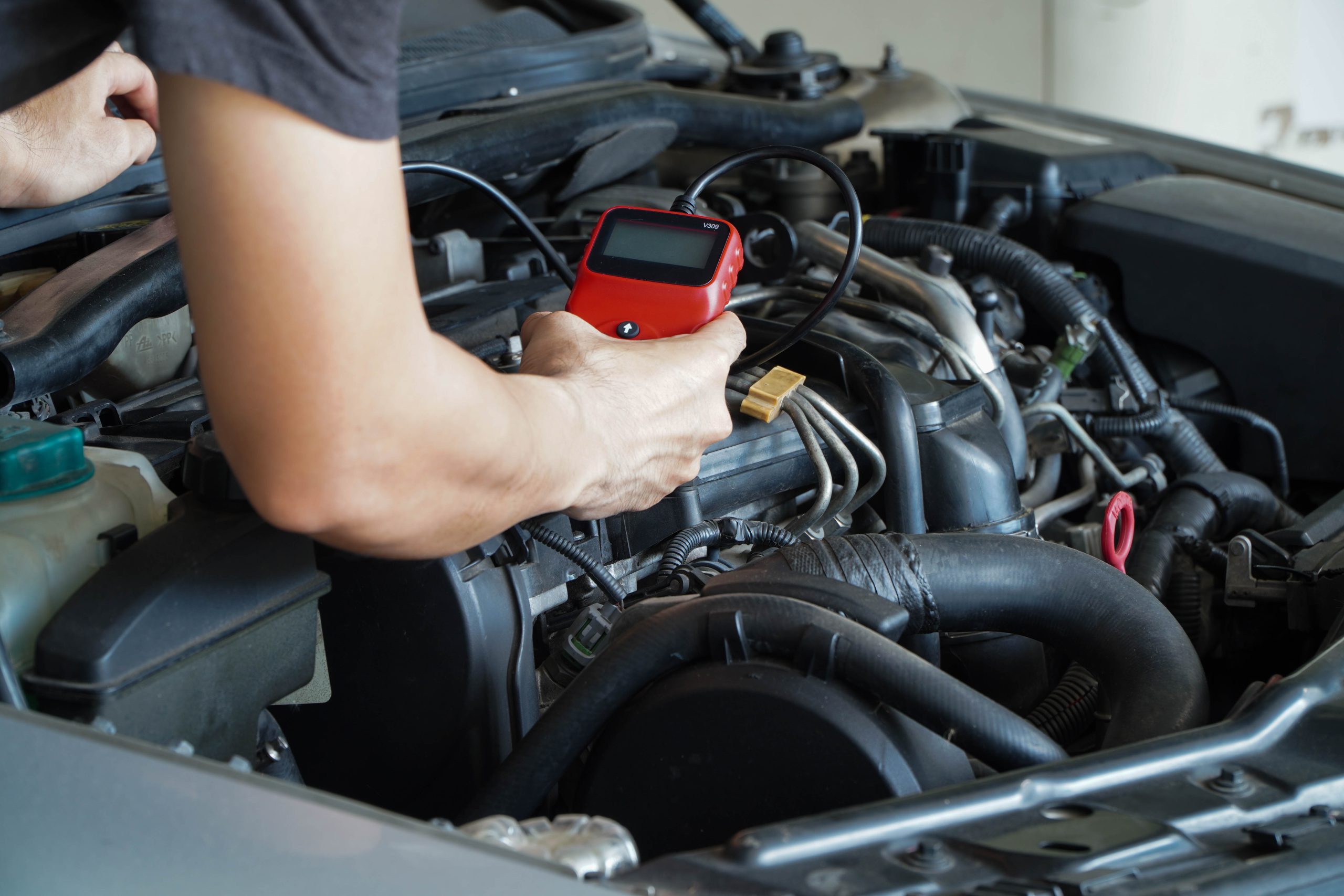 Close-up of brand-specific diagnostic tool connected to a European vehicle’s OBD port